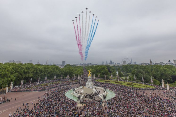 Pictured: The Red Arrows fly over Buckingham Palace MILITARY EXCELLENCE CELEBRATES MONARCHS OFFICIAL BIRTHDAY The Army performed its finest display of military pageantry to celebrate the Official Birthday of Her Majesty The Queen today on Horse Guards Parade in London. One thousand one hundred soldiers from the Household Division were joined by almost 250 immaculately groomed military horses, six blindingly polished First World War 13-Pounder Guns and 350 military musicians at the ancient annual ceremony known as Trooping the Colour. The Royal family watched from the balcony of Wellingtons office, and more than 8,500 guests including the Prime Minister, foreign dignitaries, and Defence Chiefs of Staff, filled the stands on Horse Guards, while tens of thousands of the public lined the route, as The Royal Colonels: The Duke of Edinburgh, The Duke of Kent, The Prince of Wales, The Duke of Cambridge, and The Princess Royal, accompanied Her Majesty in stately procession down the Mall to inspect the Parade.The Queens Birthday Parade, more popularly known as Trooping the Colour, is a great British tradition and one of the most complex and labour intensive events the military stages. Countless hours of planning and preparation go into making sure that the final result is as close to perfection as humanly possible in honour of Her Majesty, their Colonel in Chief. The Soldiers were on parade in the traditional ceremonial uniforms of the Household Cavalry, Royal Horse Artillery, and Foot Guards. The Welsh Guards were easily identifiable by their green and white plumed bearskins and their buttons in rows of five to indicate their place as the fifth regiment of Foot Guards. All those on parade then processed back down the Mall delivering Her Majesty safely back to Buckingham Palace. As the Royal Family appeared on the balcony at Buckingham Palace to the delight of the thousands crowded round the Queen Victoria Memorial, the Red Arrows performed a flypast.