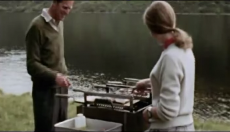 Prince Philip is helped at the BBQ by Princess Anne