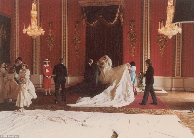 Diana's dress is arranged for the official wedding photos in the Throne Room