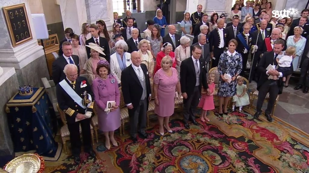The immediate families of Carl Philip and Sofia await their arrival with Prince Alexander (SVT)